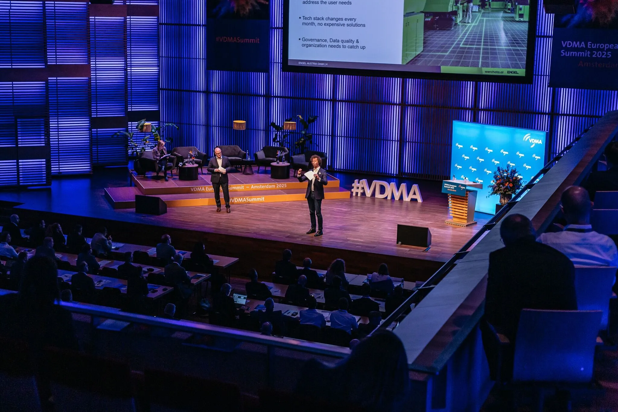 Two men speaking on stage at the VDMA European Summit 2025 in Amsterdam with audience seated in front.